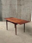 This vintage rosewood dining table is a fine example of Danish design, combining timeless aesthetics with practical functionality. The warm rosewood features a rich grain and characterful colour, giving the table an elegant and inviting appearance. With e