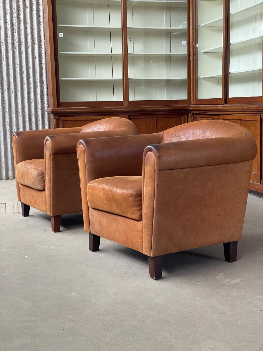 Vintage pair leather clubchairs in brown 