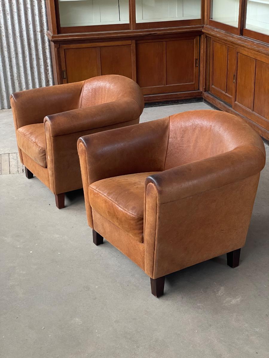 Vintage pair leather clubchairs in brown 