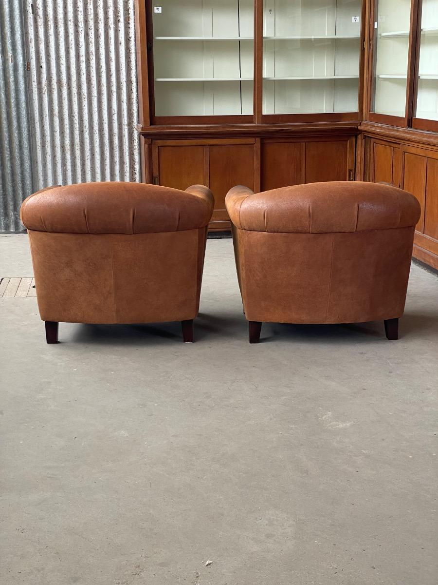 Vintage pair leather clubchairs in brown 