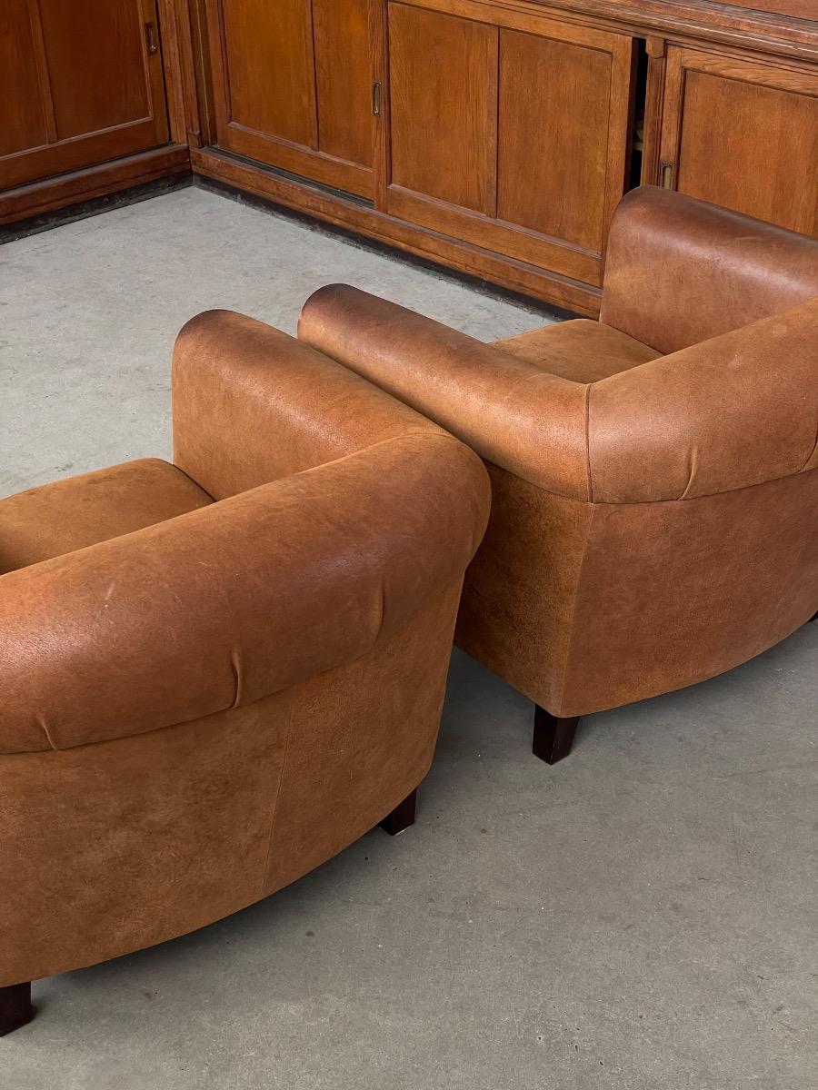 Vintage pair leather clubchairs in brown 