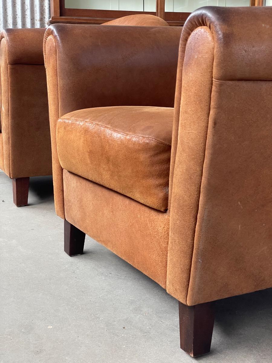 Vintage pair leather clubchairs in brown 