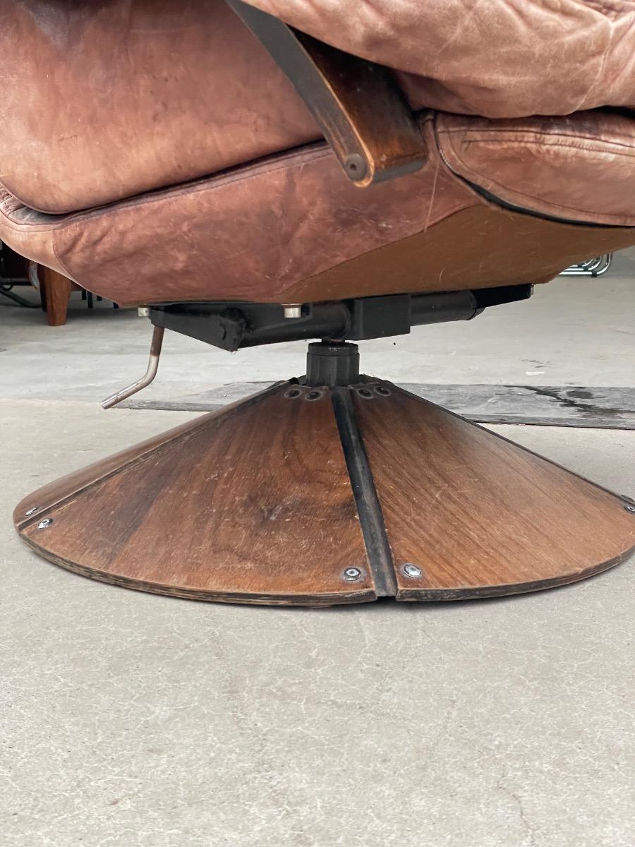 Vintage swivel armchair in brown leather on wooden base 1960s